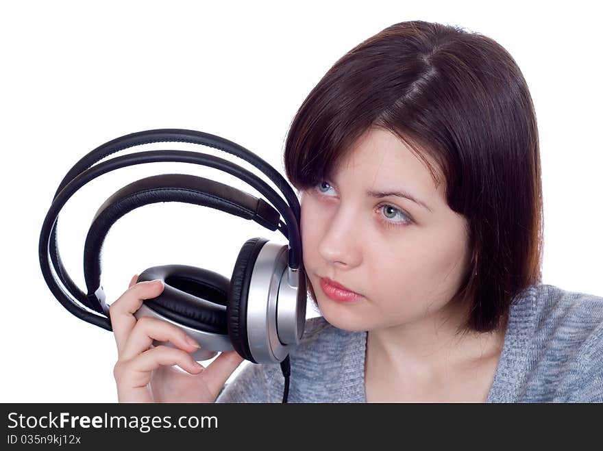 The girl in ear-phones on a white background