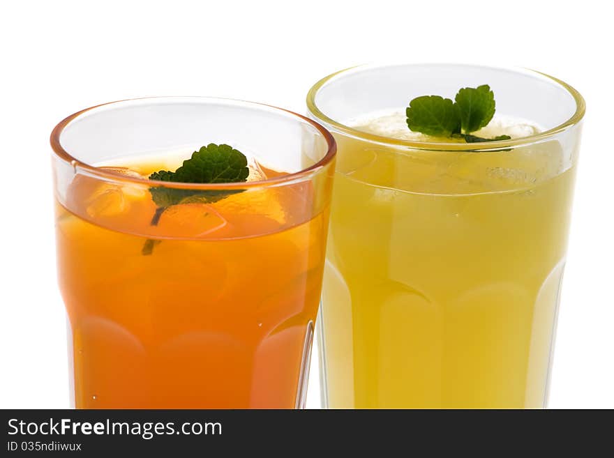 Closeup of two glasses of drinks on a white background. Closeup of two glasses of drinks on a white background