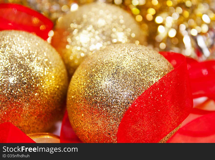 Golden christmas balls with red ribbon in white background for christmas eve