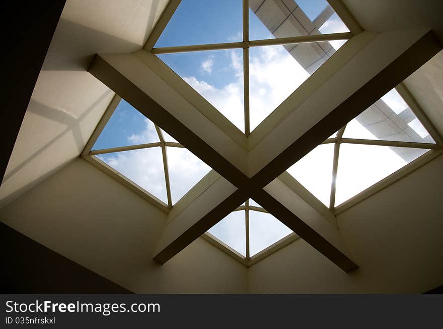 Cross ceiling windows with blue sky