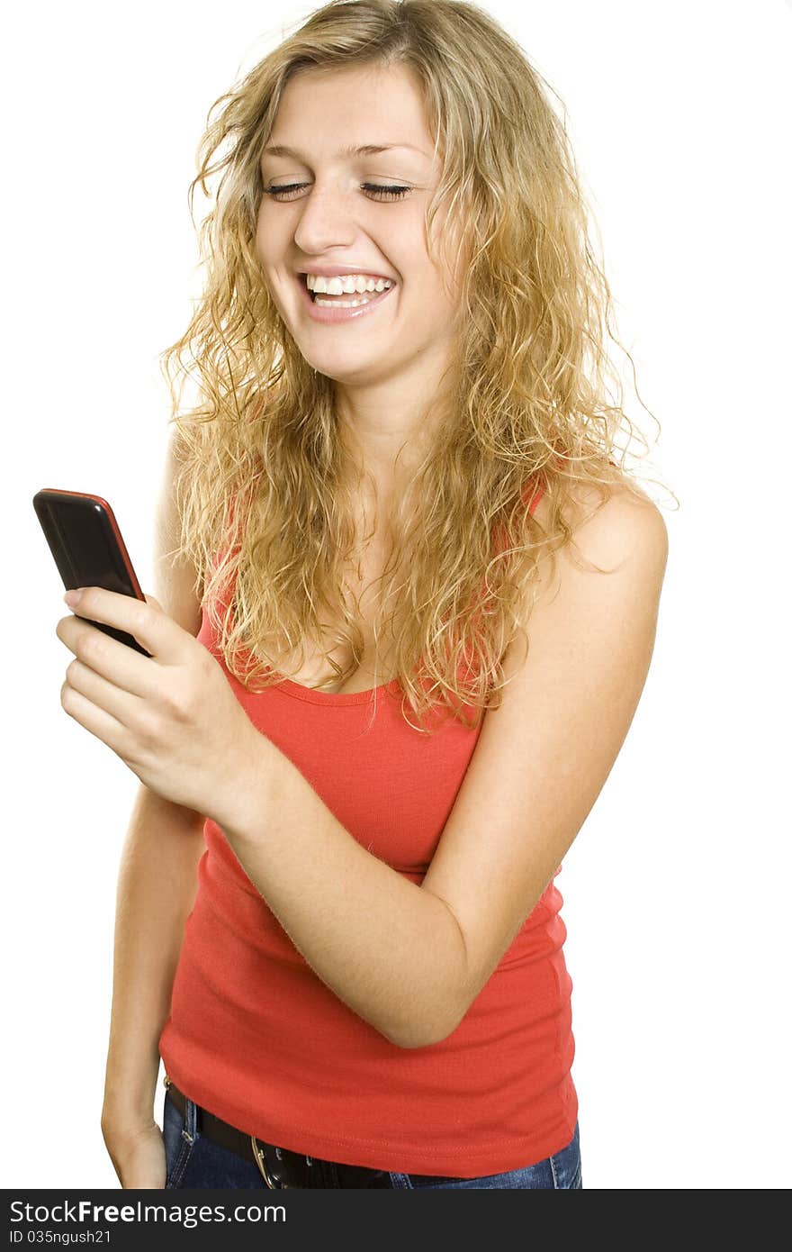 Closeup of an attractive blonde reads text messages from mobile phones and expresses the joy and laughter. Isolated on white background. Closeup of an attractive blonde reads text messages from mobile phones and expresses the joy and laughter. Isolated on white background