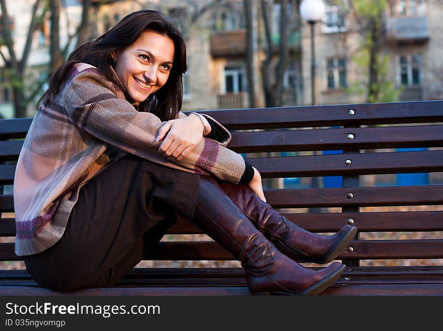 Beautiful young woman on a bench in autumn. Beautiful young woman on a bench in autumn