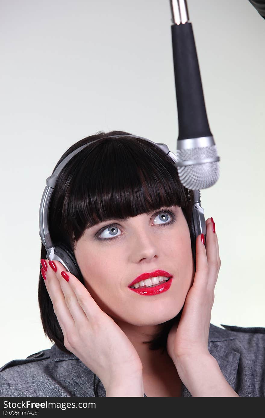 Young Woman Singer On Gray Background