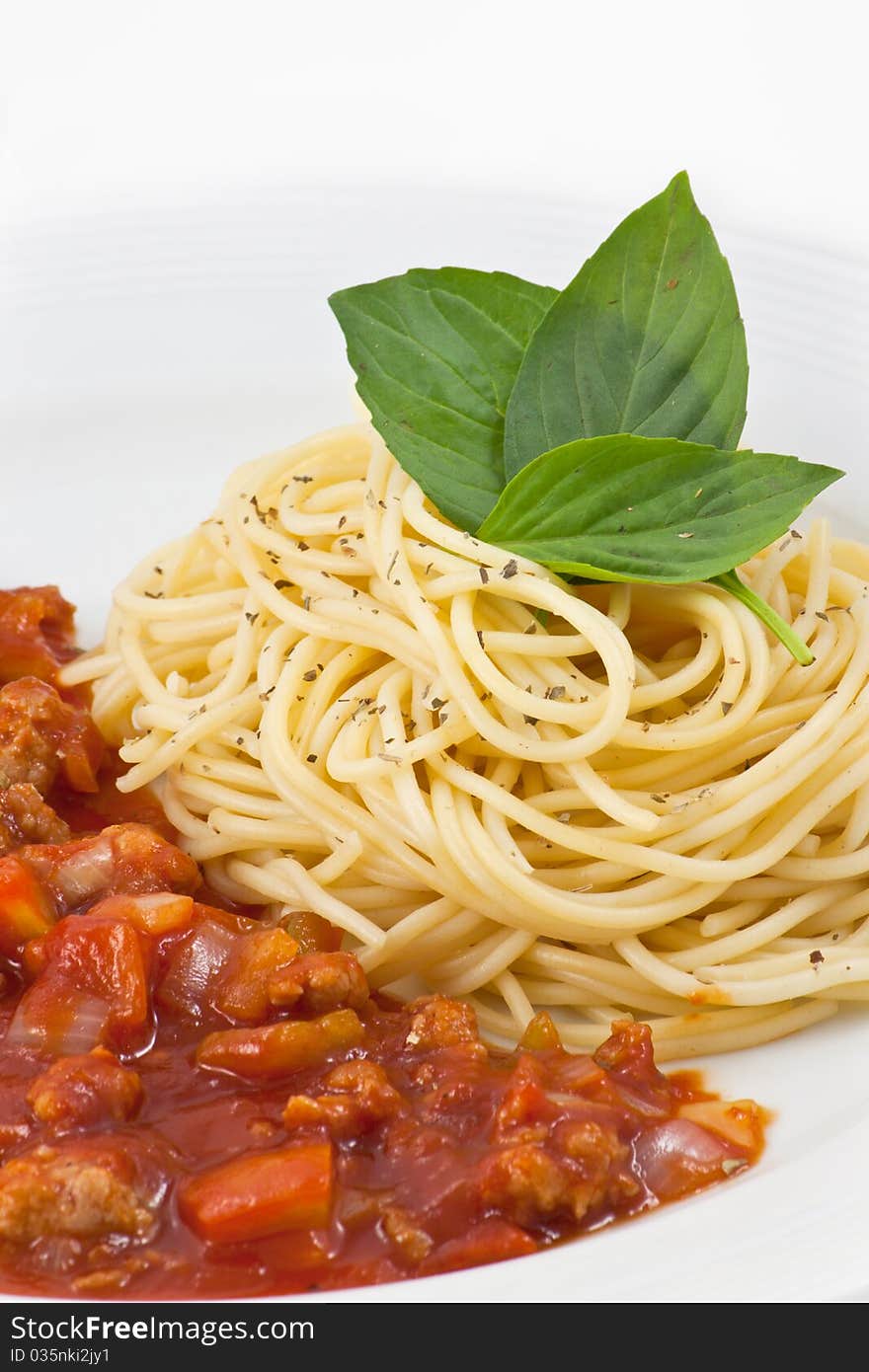 Spaghetti with tomato sauce in plate on white background