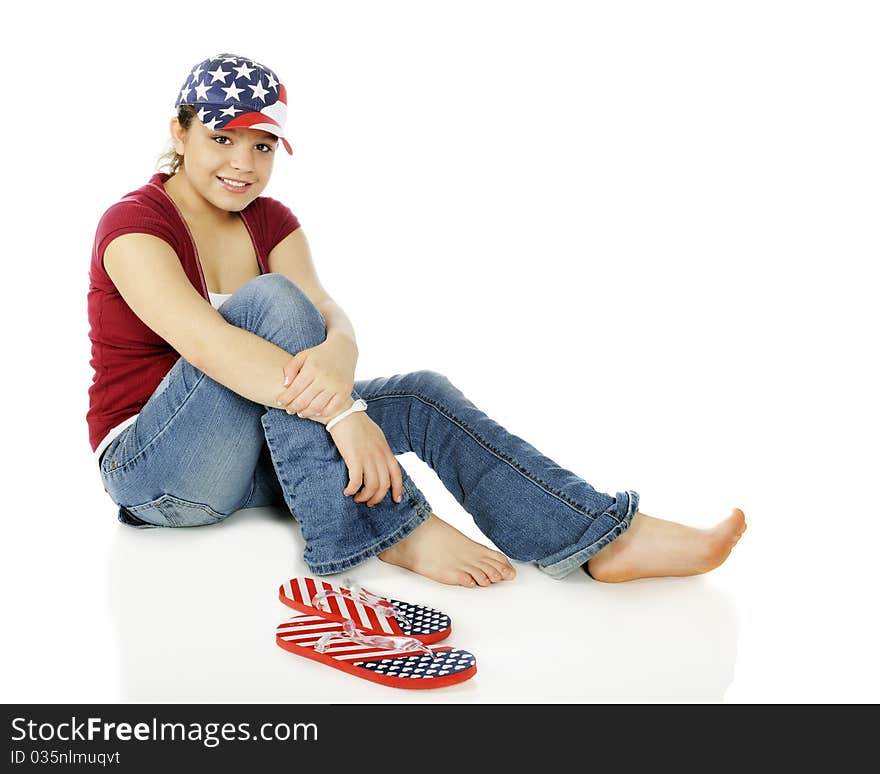 Portrait of a beautiful young American teen wearing stars and stripes on her hat and flip-flops,. Portrait of a beautiful young American teen wearing stars and stripes on her hat and flip-flops,