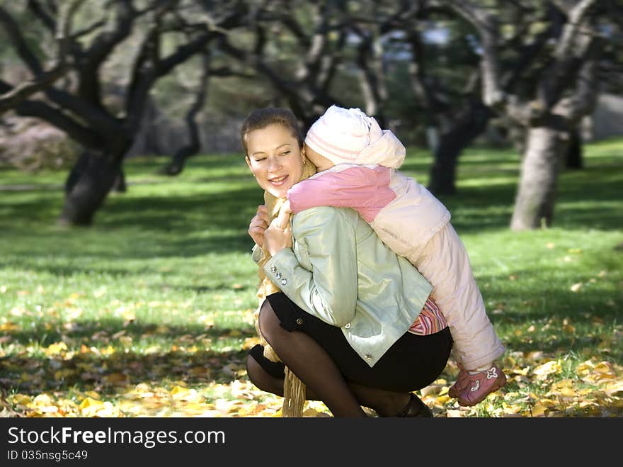 mother and daughter playing outdoors. mother and daughter playing outdoors