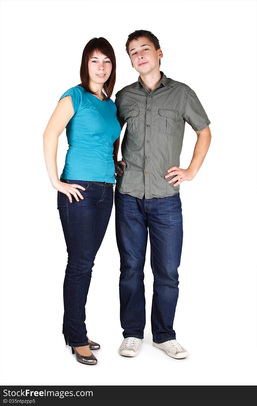 Young brunette man and girl in jeans standing and looking at camera, isolated