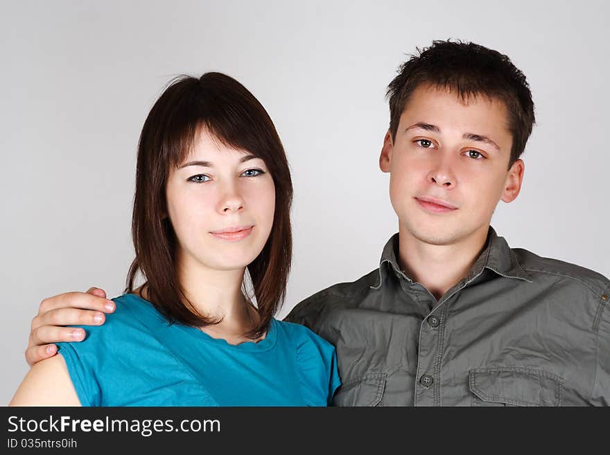 Portrait of man embracing brunette girl and looking at camera. Portrait of man embracing brunette girl and looking at camera