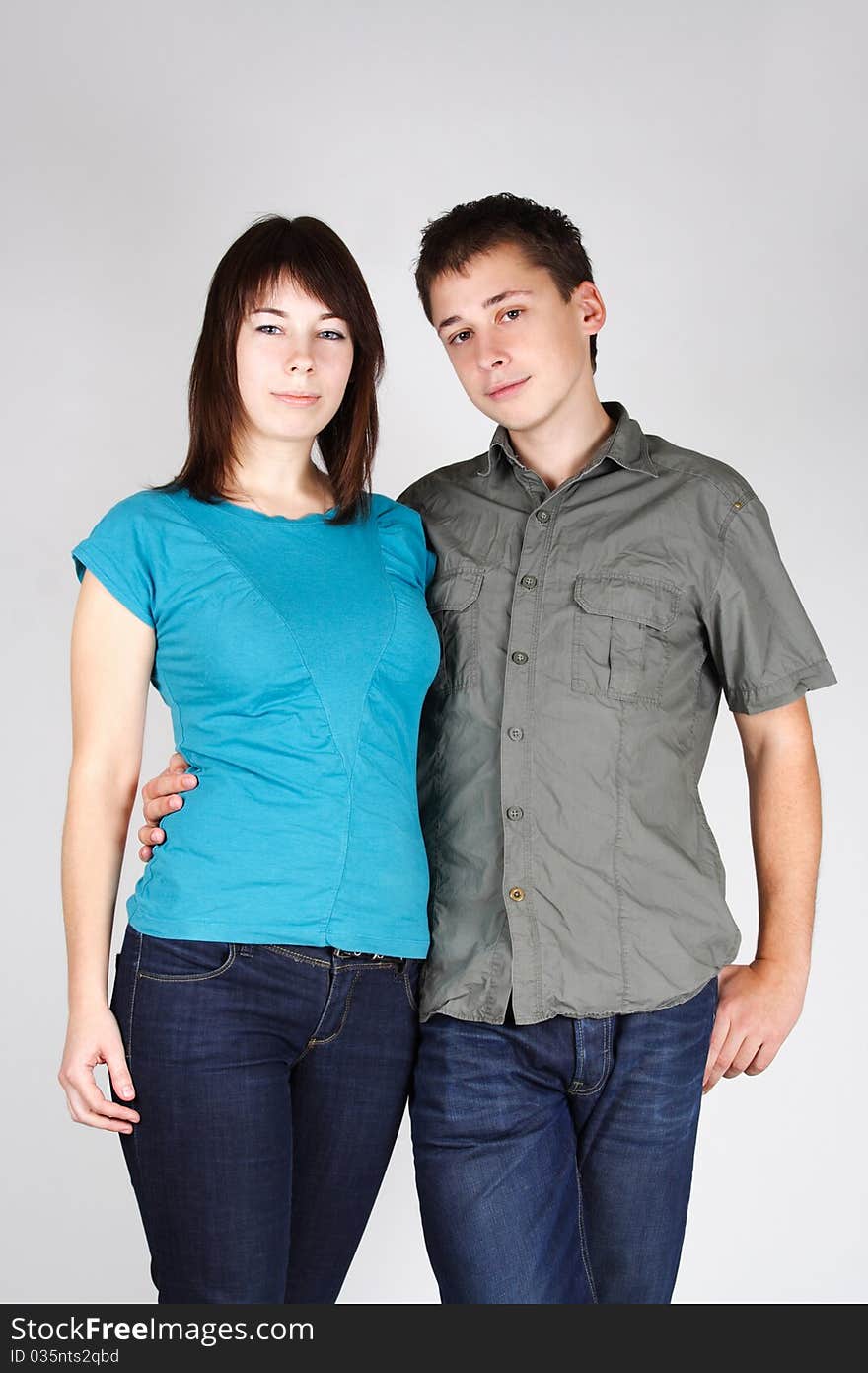 Portrait of man embracing brunette girl and looking at camera. Portrait of man embracing brunette girl and looking at camera