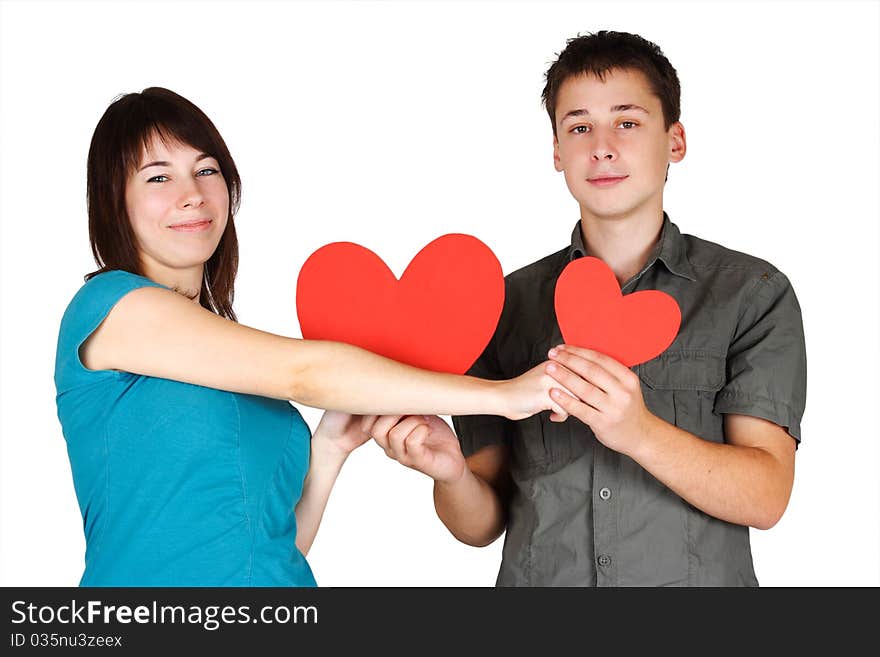 Girl and man holding two paper hearts, smiling