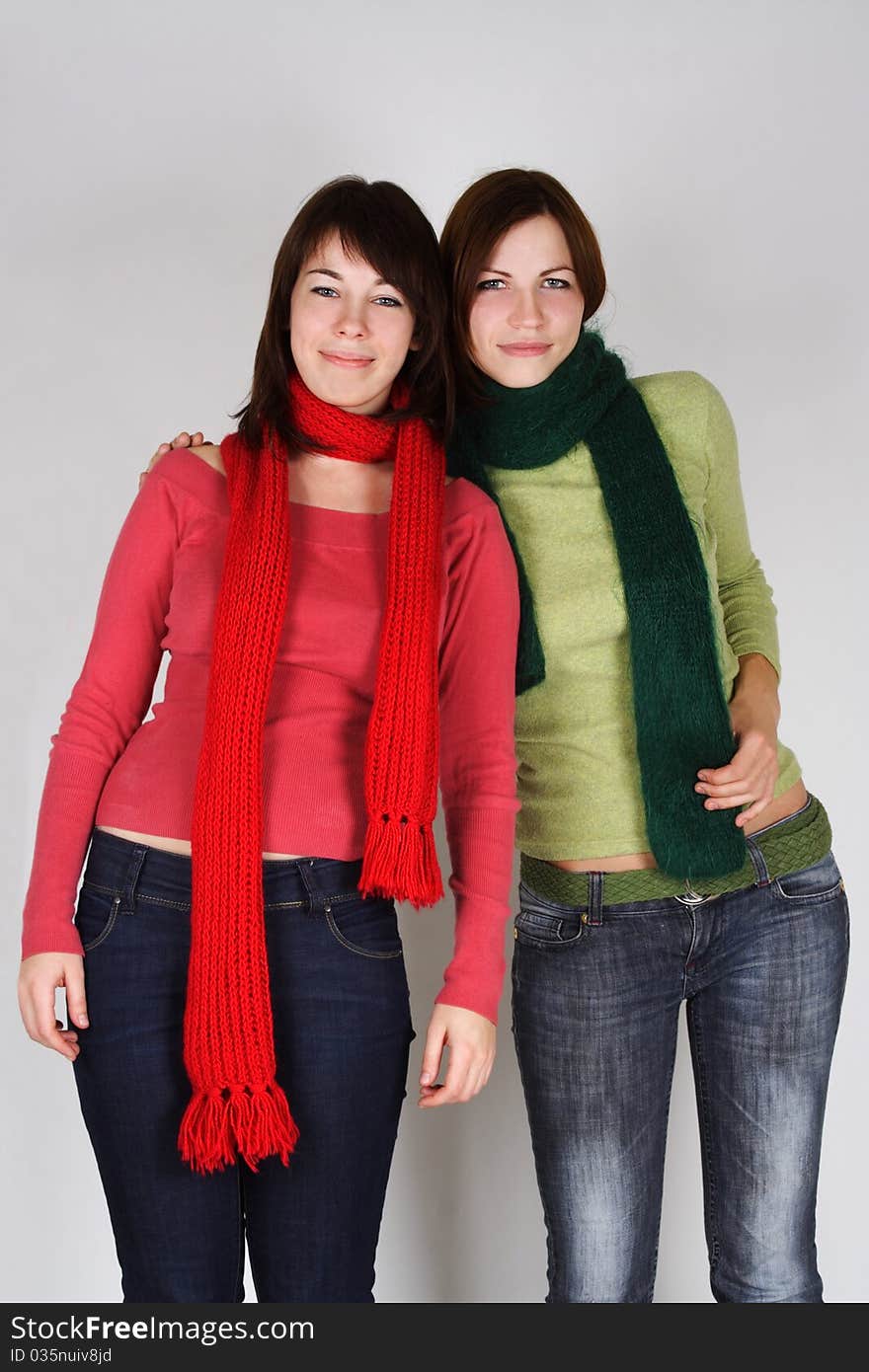 Portrait of two young girls in green and red scarfs