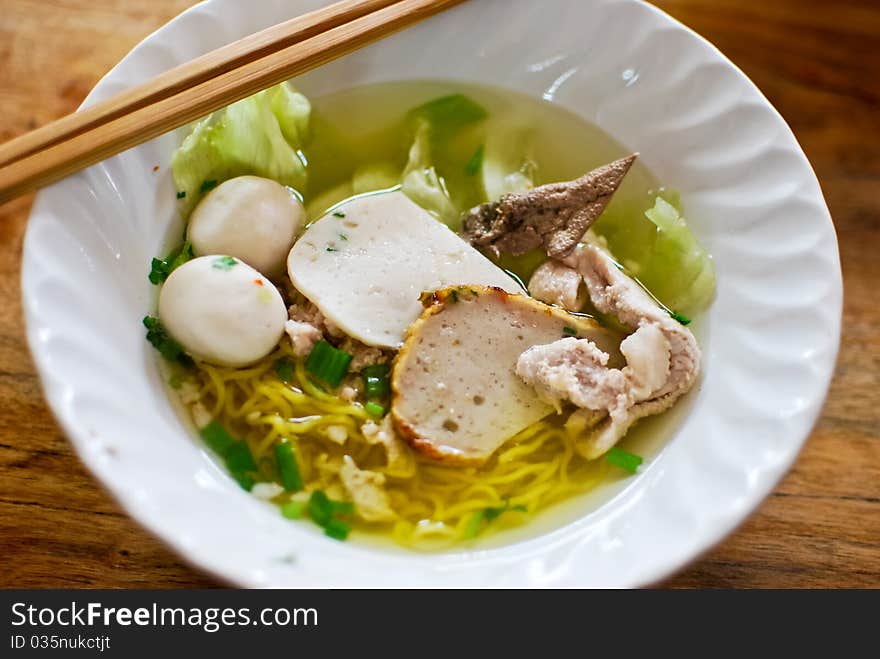 Asian style noodle with pork , fish ball and vegetables