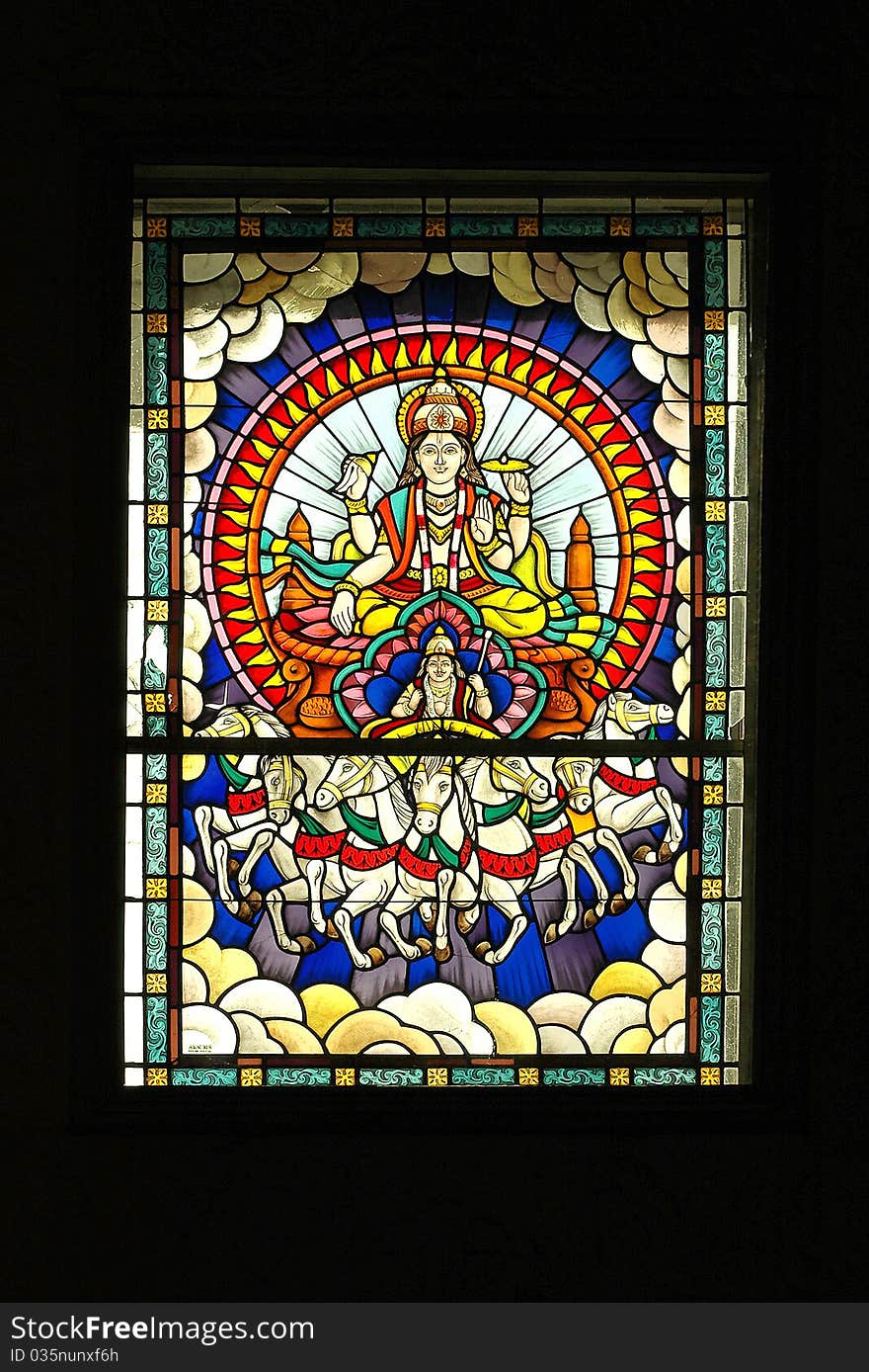 Stained glass window showing Lord Vishnou riding across the skies in a horse-drawn carriage. Stained glass window showing Lord Vishnou riding across the skies in a horse-drawn carriage