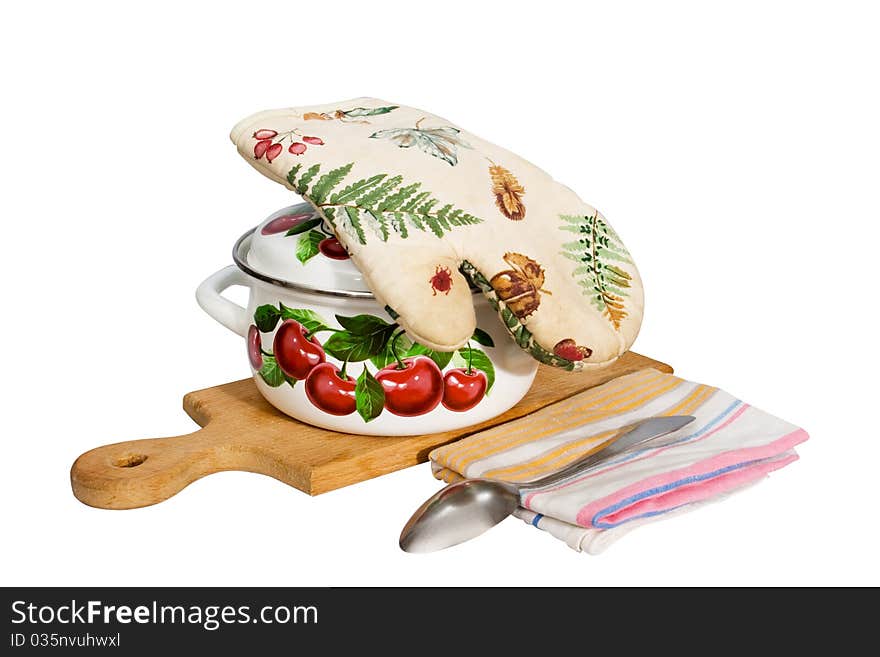 A metal pan and kitchen utensils on a cutting board.