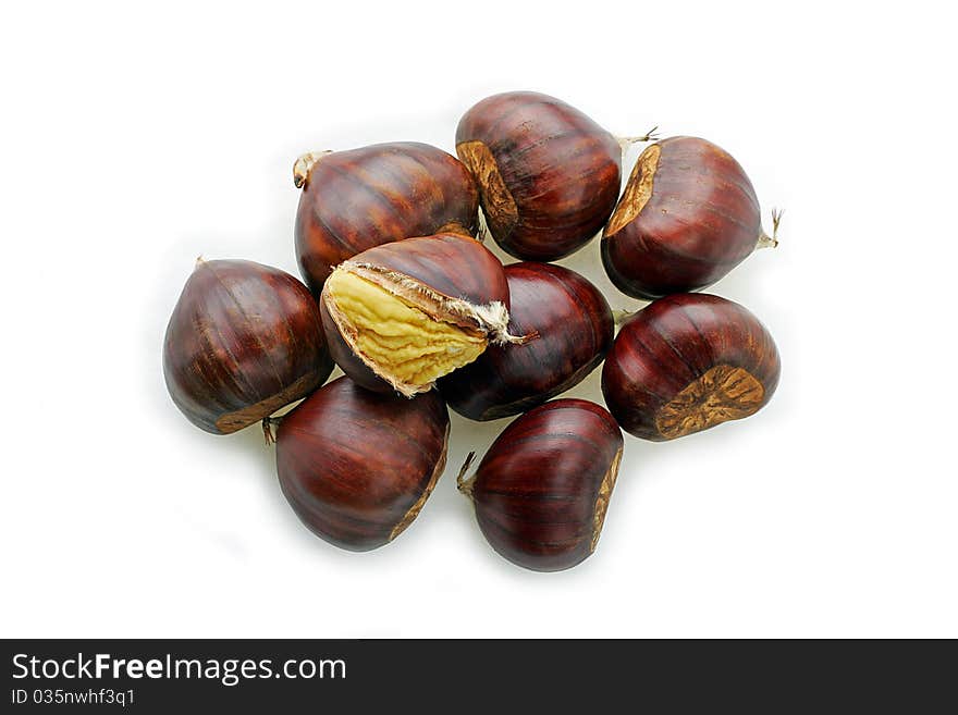 Nine chestnuts one with the husk open to show the nut. Nine chestnuts one with the husk open to show the nut