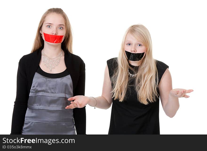 Two beautiful girls with their mouths taped with tape