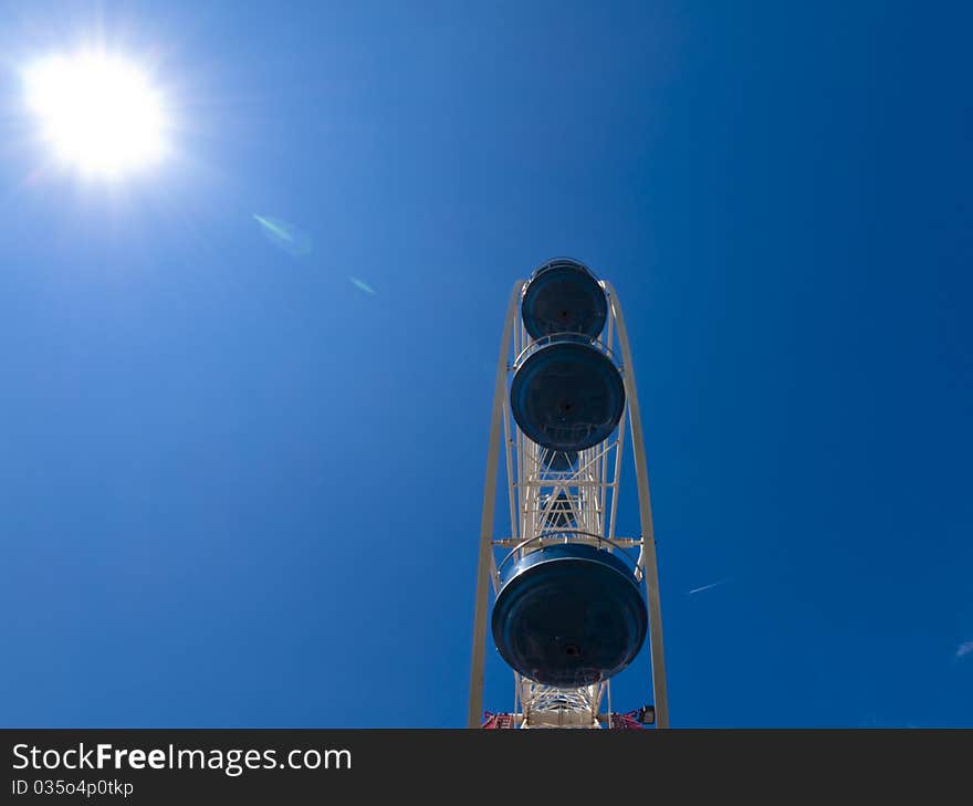 White ferris wheel with blue sky in the background