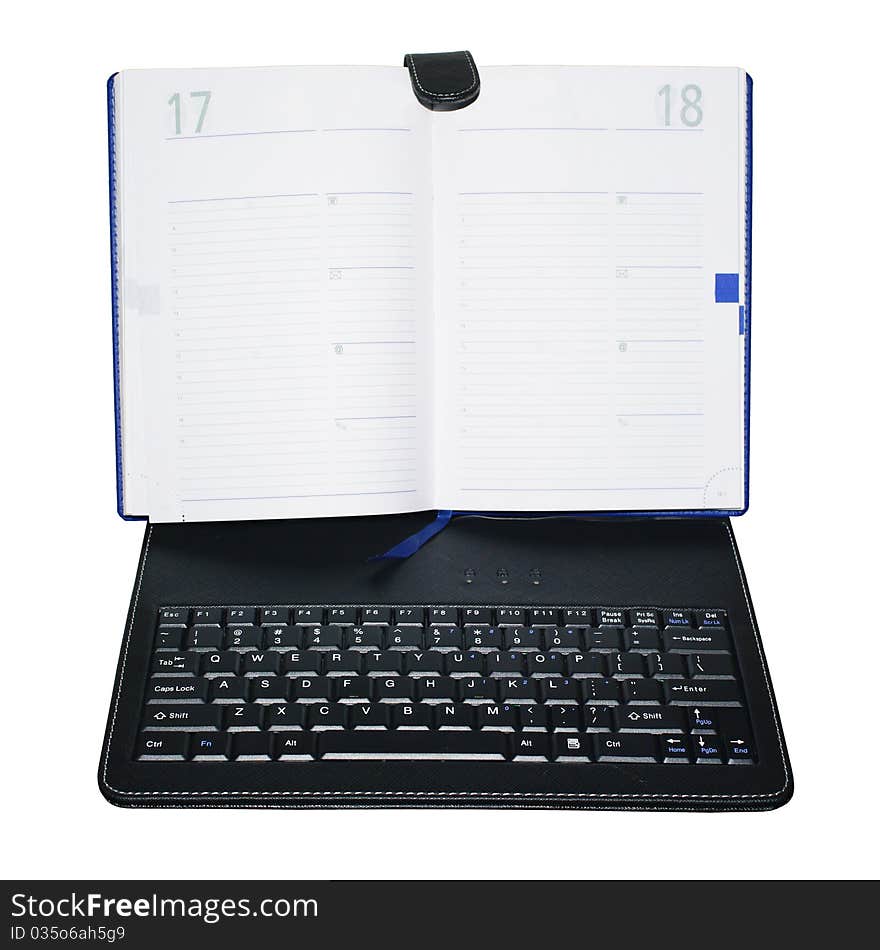 An unusual device that combines a paper notebook and laptop keyboard. Isolation.