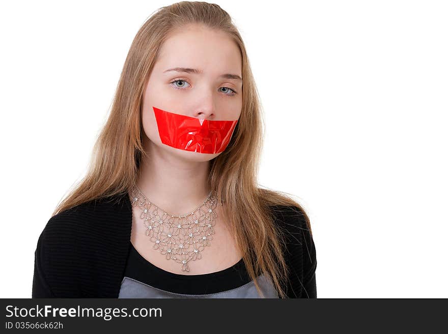 Beautiful girl with her mouth sealed with red tape