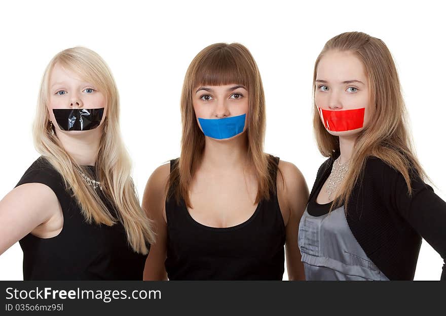 Three beautiful girls with their mouths taped with tape