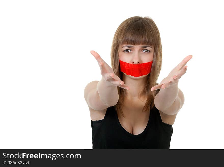 Beautiful girl with her mouth sealed with red tape