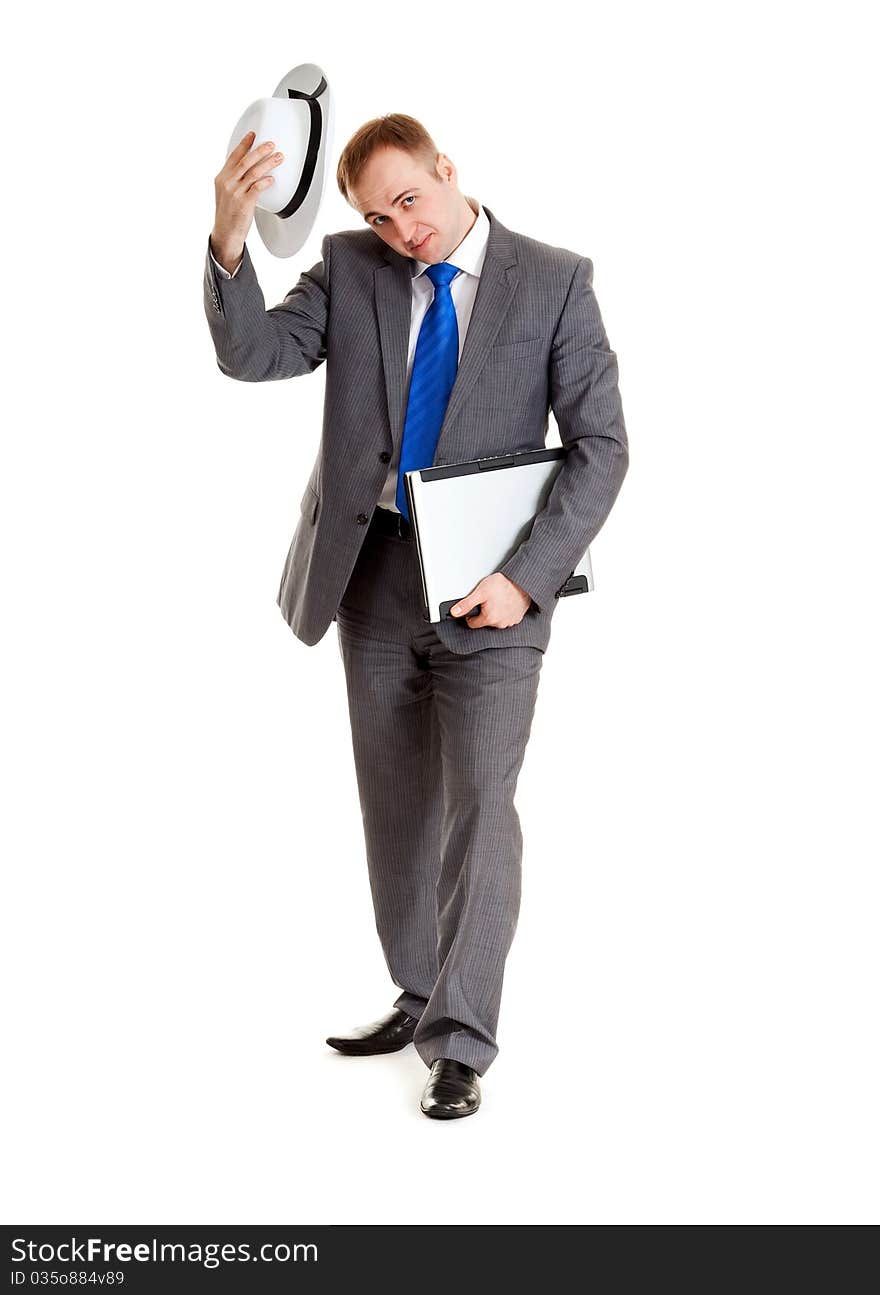 Young businessman in a suit and a hat with a laptop