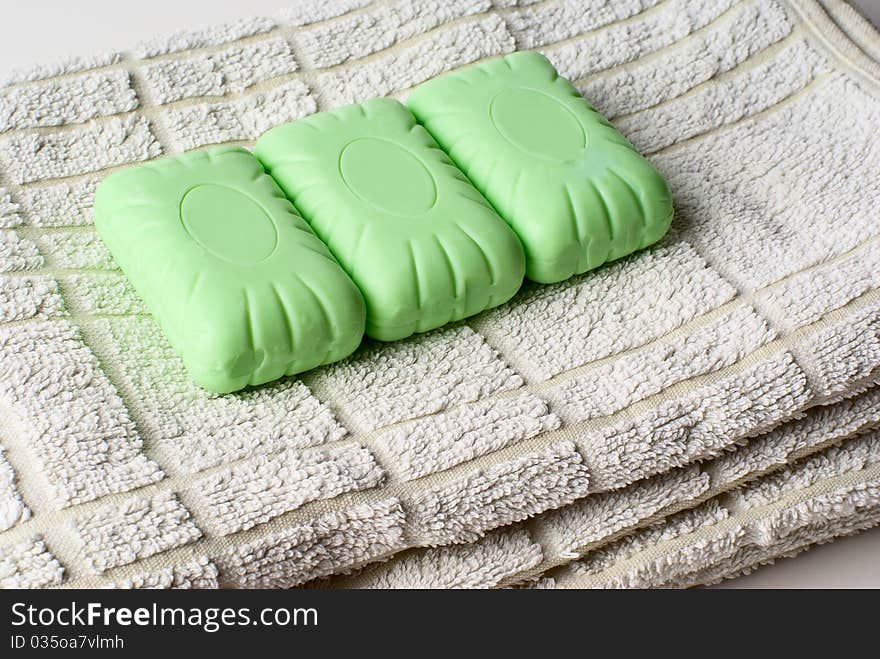 Three pieces of soap lying on towel. Three pieces of soap lying on towel.