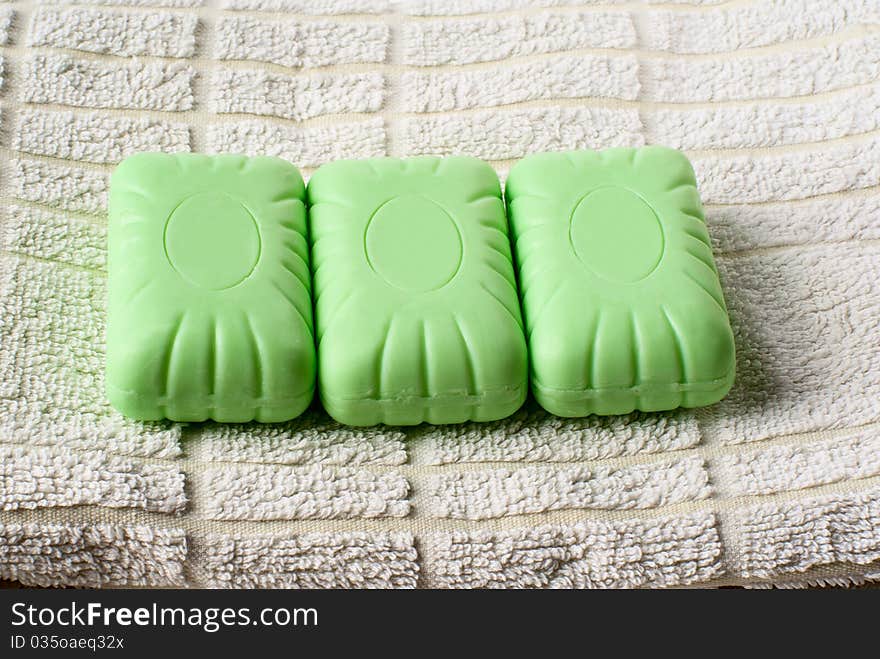 Three pieces of soap lying on towel. Three pieces of soap lying on towel.