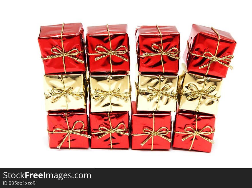 Gift red boxes with gold bows on a white background