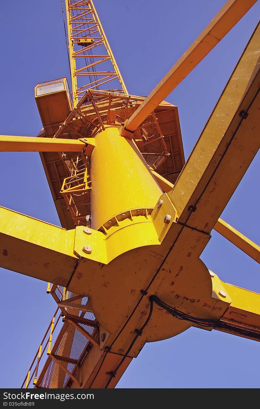 A view of a heavy high cargo crane from below. A view of a heavy high cargo crane from below