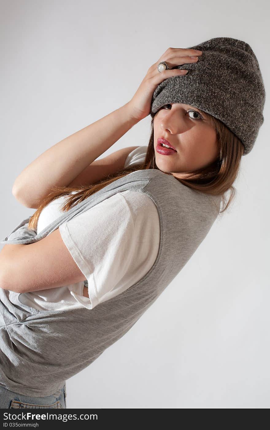 A cute picture of a young model posing in a gray hat, gray vest, and white shirt. A cute picture of a young model posing in a gray hat, gray vest, and white shirt.