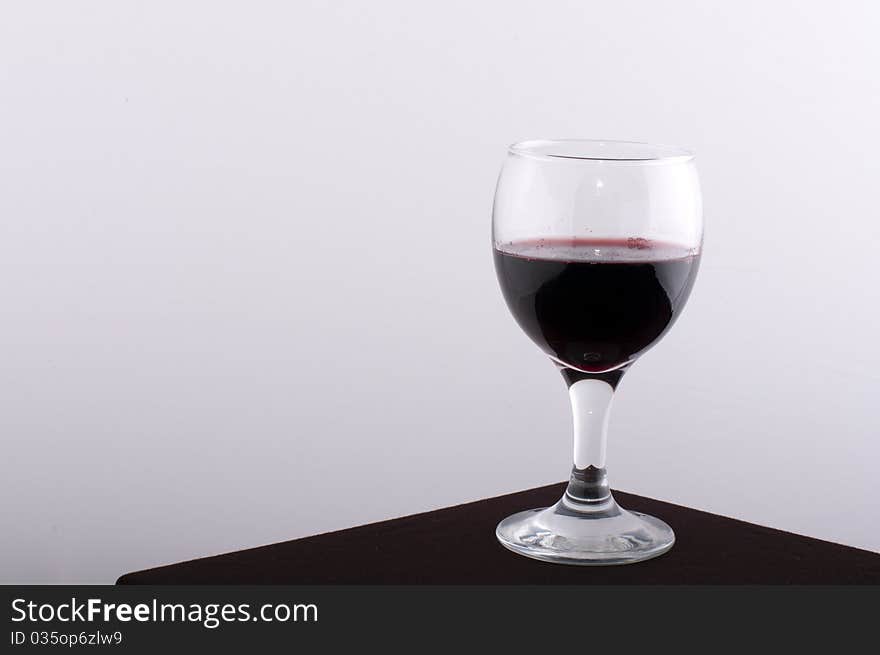 Glass wine glasses on a brown table with a white background. Glass wine glasses on a brown table with a white background