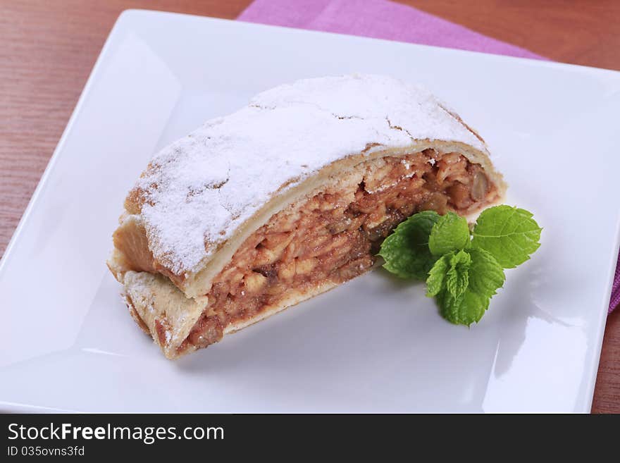 Slice of apple strudel powdered with icing sugar