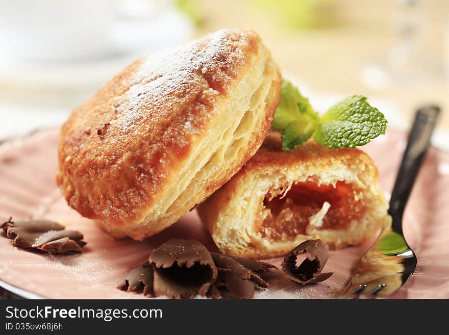 Jam filled donuts on a pink plate