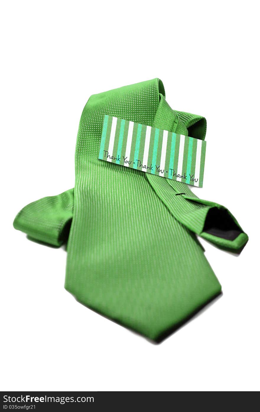 Green tie with a thank you card for the man in your life, isolated on a white background. Green tie with a thank you card for the man in your life, isolated on a white background