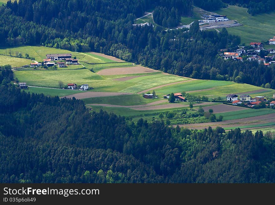 A village surrounded by green forested mountains near Innsbruck in Austria. A village surrounded by green forested mountains near Innsbruck in Austria