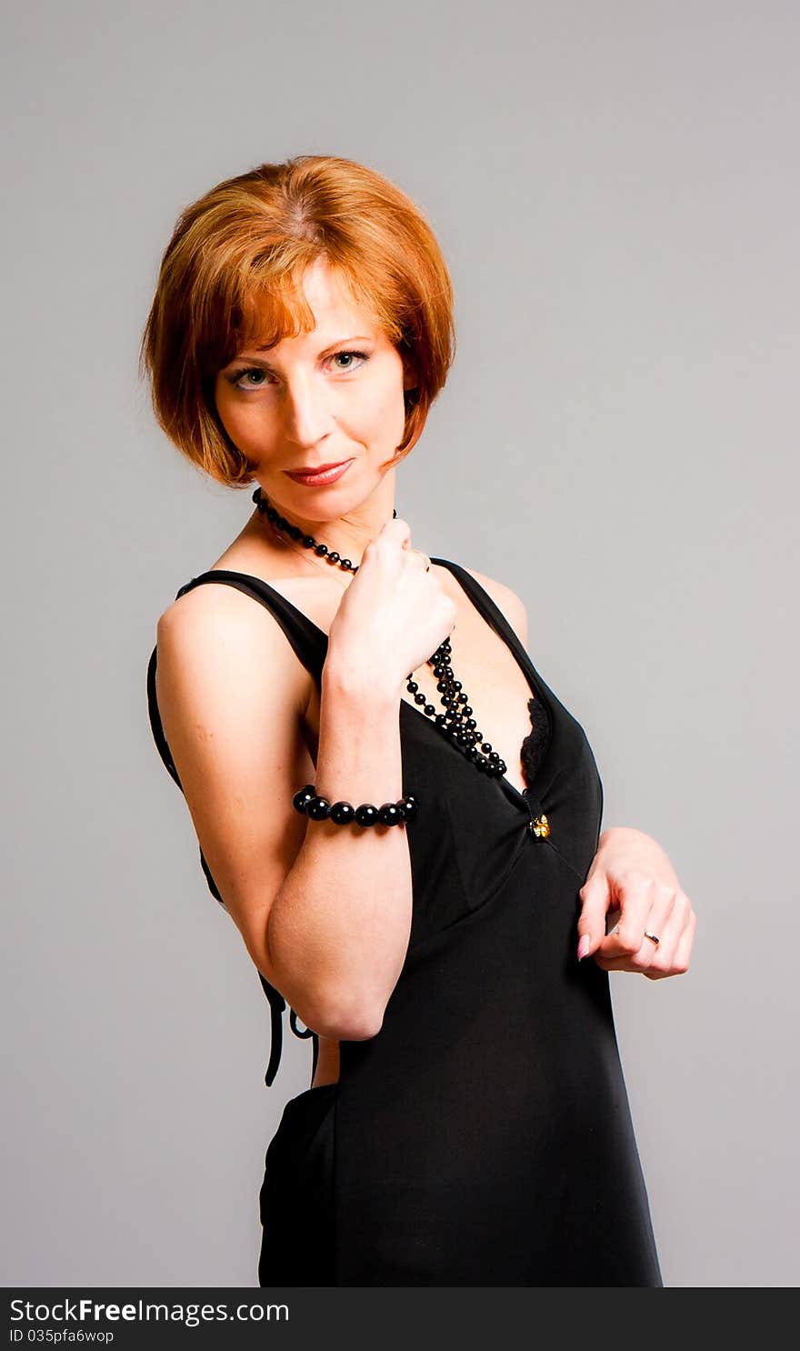 Charming young woman in a black dress in studio. Charming young woman in a black dress in studio