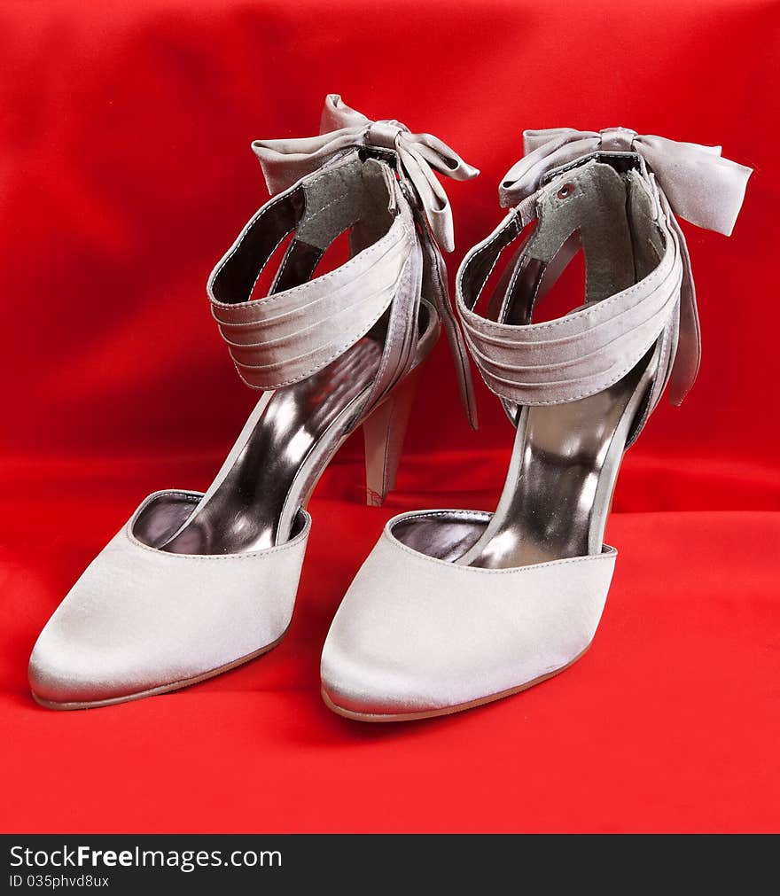 Pair of white women's shoes on a white background