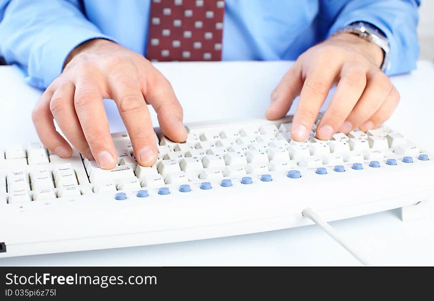 Male hands on a white keyboard. Male hands on a white keyboard