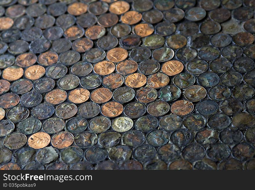 A shot of a floor at a restaurant in California covered in pennies. A shot of a floor at a restaurant in California covered in pennies