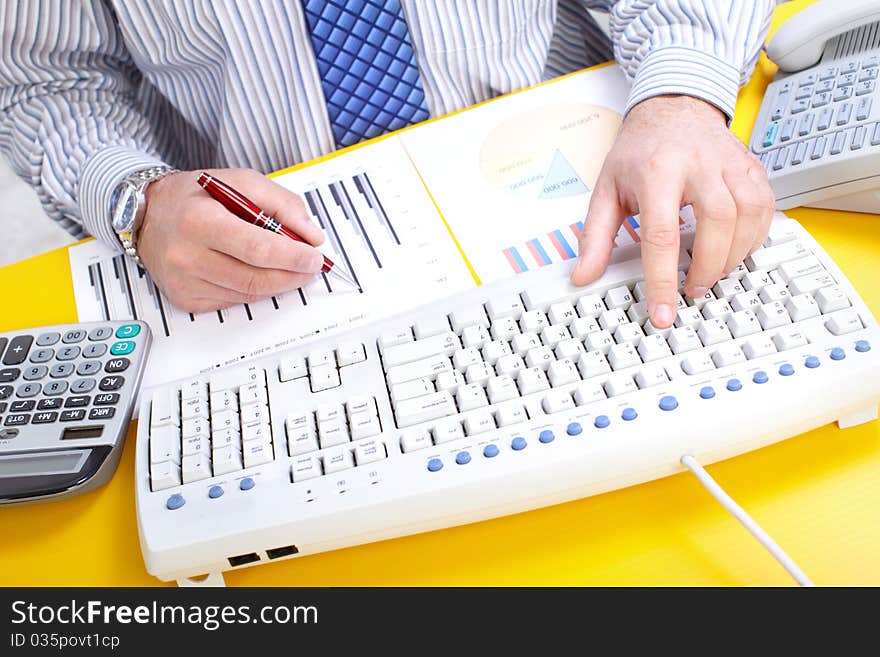 Male hands typing on a white keyboard