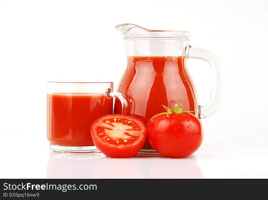 Fresh tomatoes and a glass full of tomato juice. Fresh tomatoes and a glass full of tomato juice