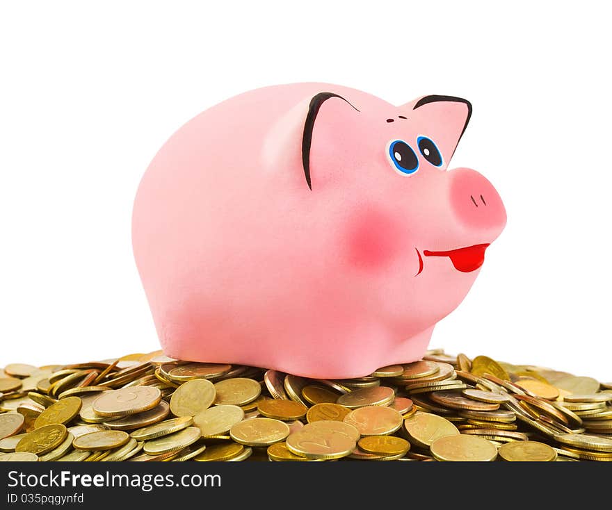 Piggy bank and heap of coins isolated on white background