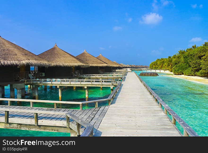 Water bungalows on a tropical island - travel background