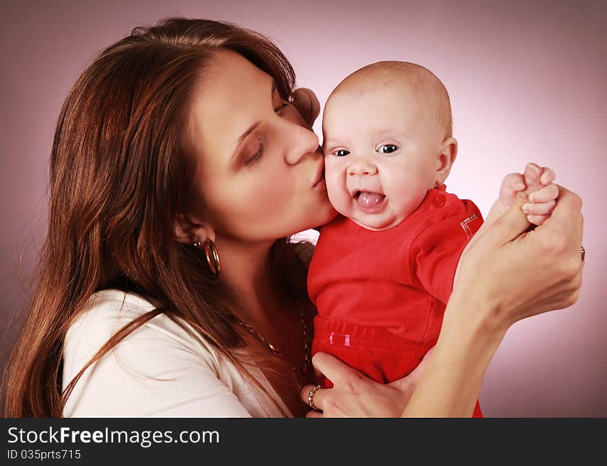 Young mother kissing her little child. Young mother kissing her little child