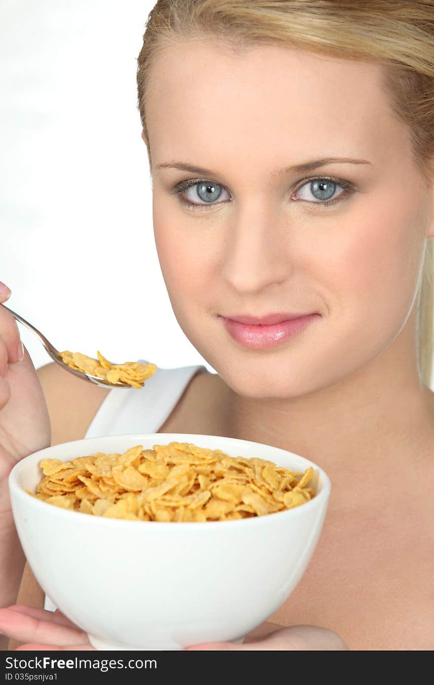 Portrait of a young woman eating cereals