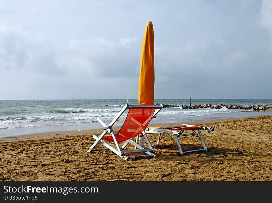 Sunshade and sun lounger on the beach