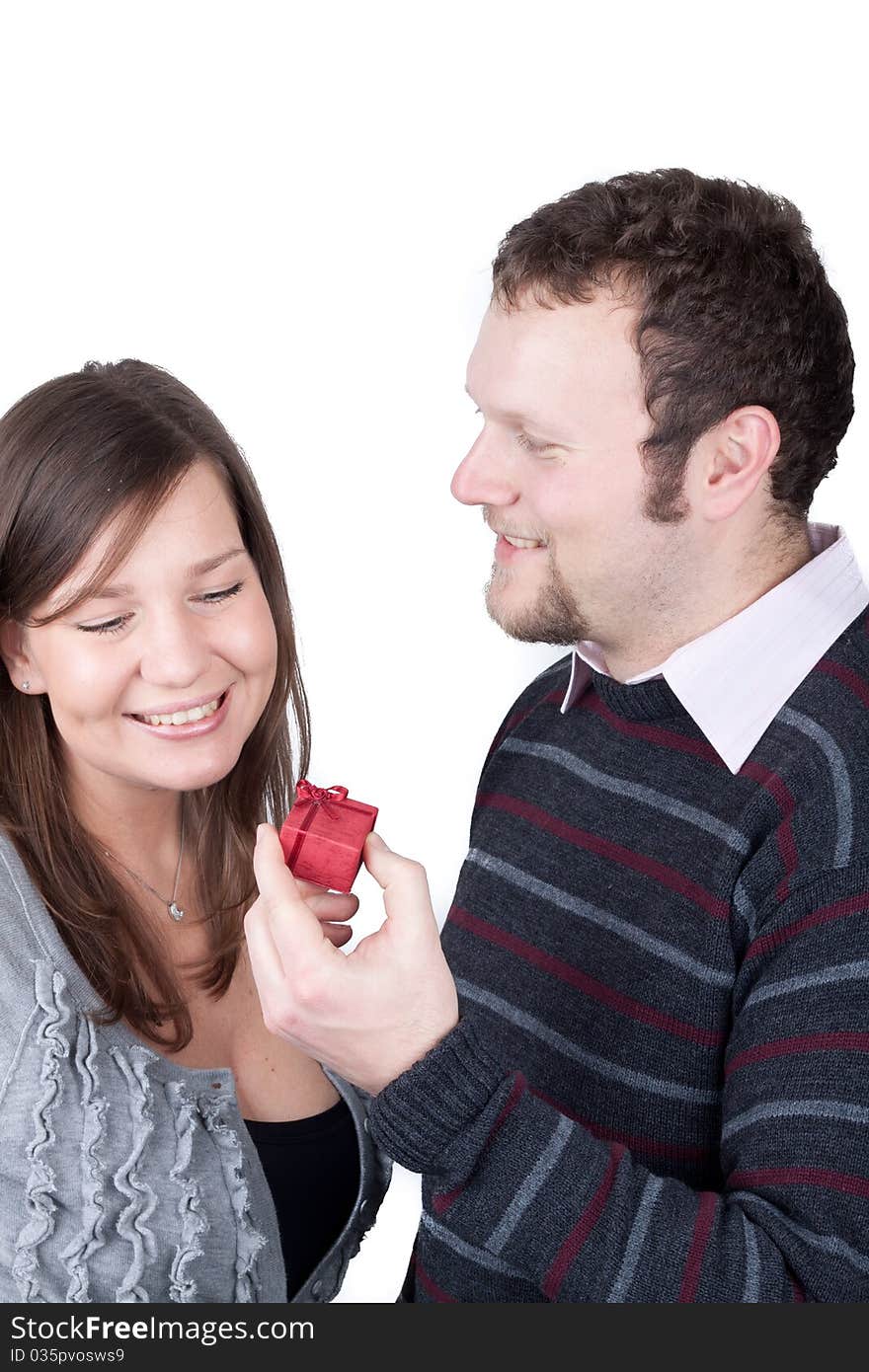 Handsome guy giving a present to his girlfriend isolated over a white background