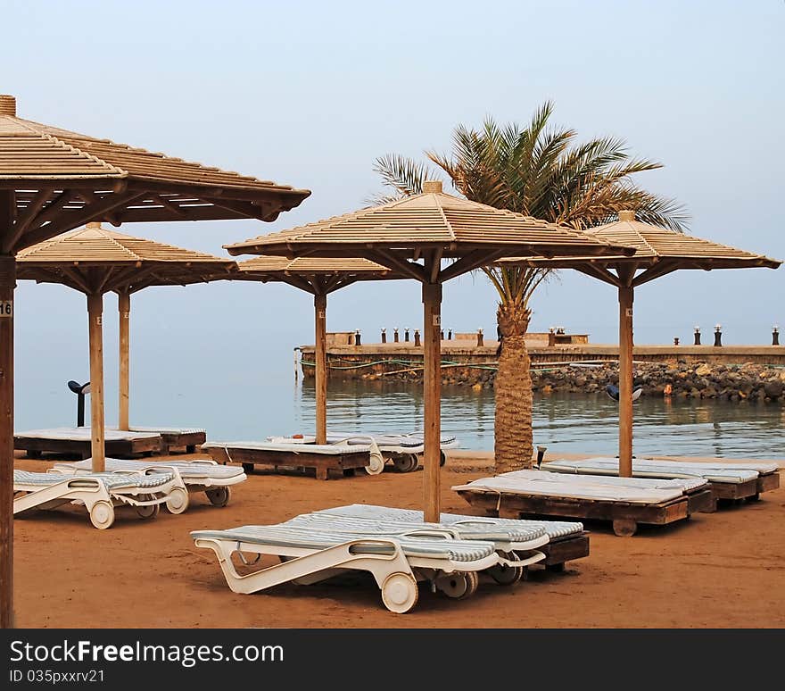 Plank beds on a beach at the sea