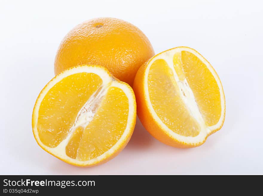 Ripe orange and half on white background. Ripe orange and half on white background